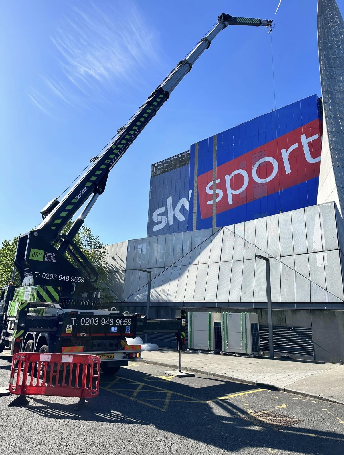 Böcker crane operating in front of the Sky Sports facade